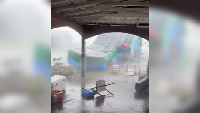 Strong winds in Florida send a bounce house tumbling.
