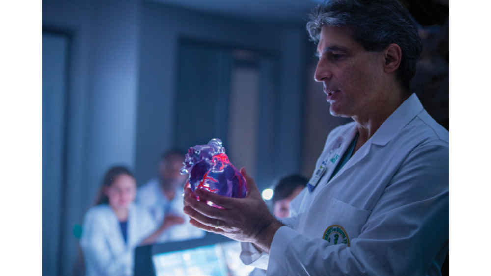 Dr. Fadi Matar examines a 3D-printed heart model at Tampa General Hospital.