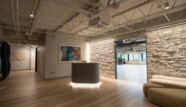 Reception area inside Power Design wellness center with stone wall and fitness studio entrance