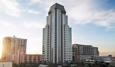 200 Central Avenue office tower rises above downtown St. Petersburg skyline at sunset.