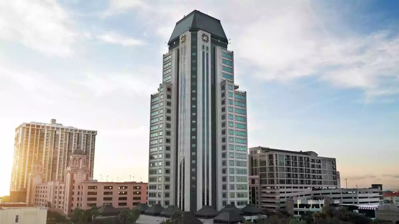 200 Central Avenue office tower rises above downtown St. Petersburg skyline at sunset.