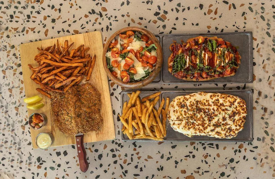 From left to right, clockwise: a New York Strip milanesa, a Chicken Margherita milanesa, and a Neapolitan milanesa, from the menu at La Casa de La Milanesa, located in the Midtown area of Miami, on Tuesday, May 26, 2026.