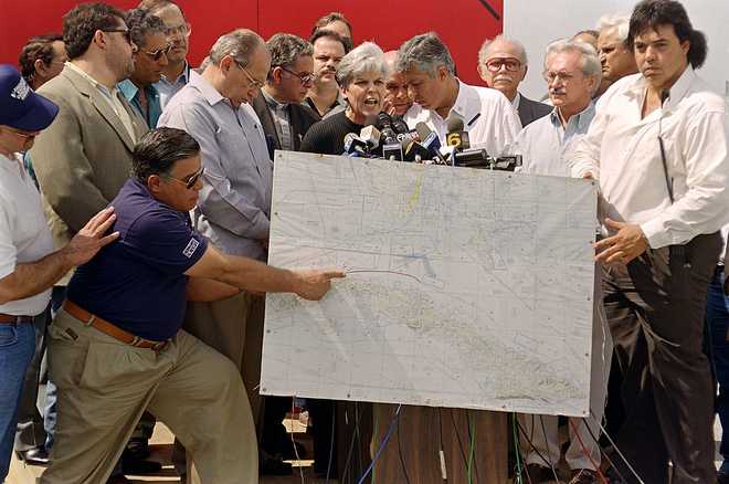 Members of "Brothers to the Rescue" hold a press c MIAMI, FL - FEBRUARY 25: Members of "Brothers to the Rescue" hold a press conference 25 February 1996 with a map showing the location where two of their planes were shot down by Cuban fighter jets off the Cuban coast 24 February. Hundreds of Cuban-Americans staged a rally 25 February after hearing that two "Brothers to the Rescue" planes were shot down by Cuban fighter jets over international waters near Cuba. "Brothers to the Rescue" is a Miami-based group dominated by Cuban exiles opposed to Castro that trolls the waters between Florida and Cuba looking for small boats of Cuban refugees and also drops political leaflets over Cuba. (Photo credit should read RHONA WISE/AFP via Getty Images)