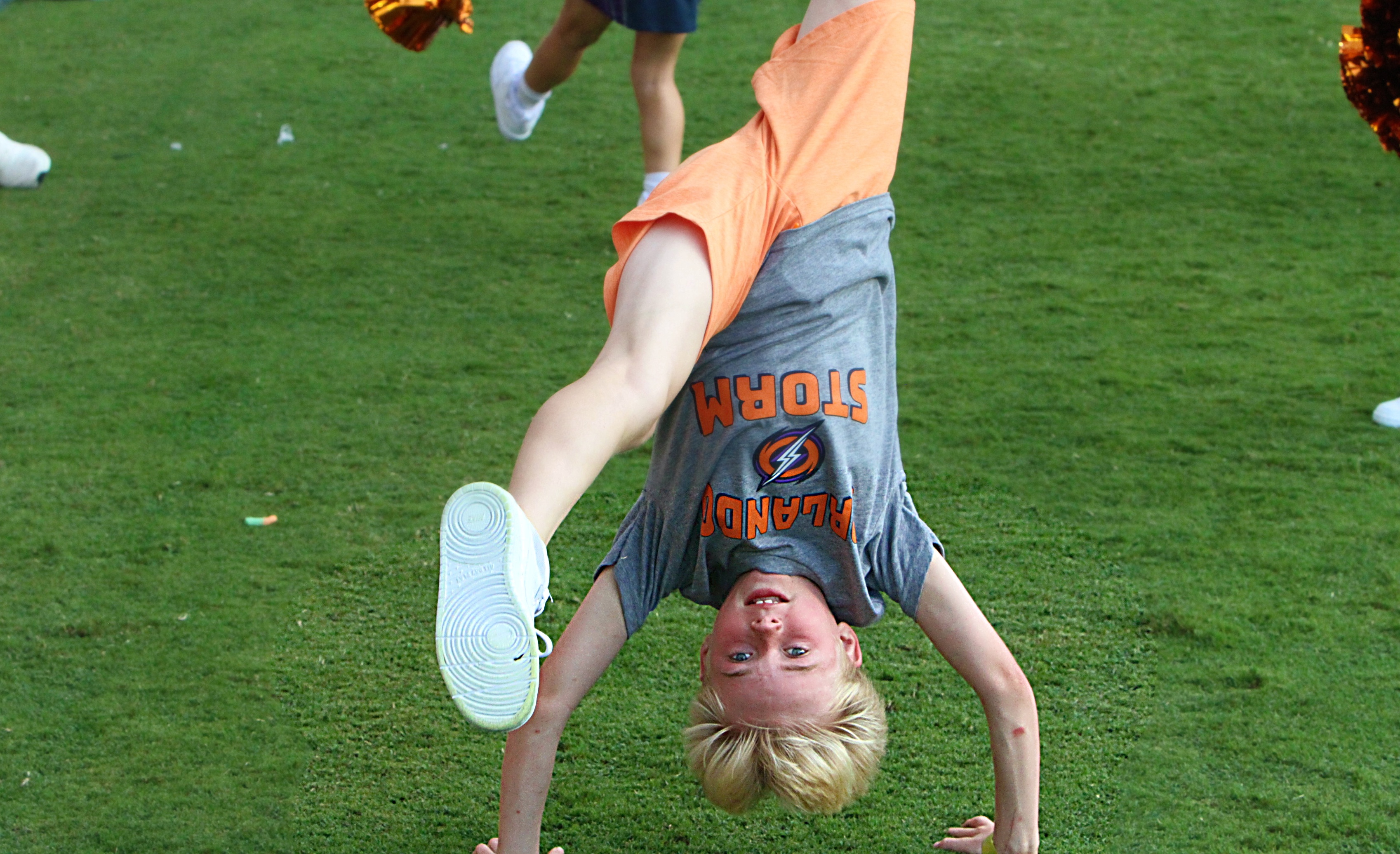 A young Orlando Storm Surge yell leader does a back...