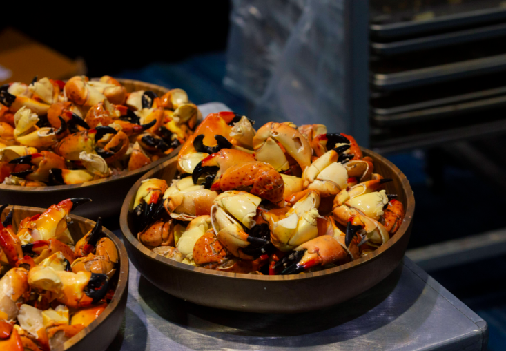 Bowls filled with stone crab claws with steam rising