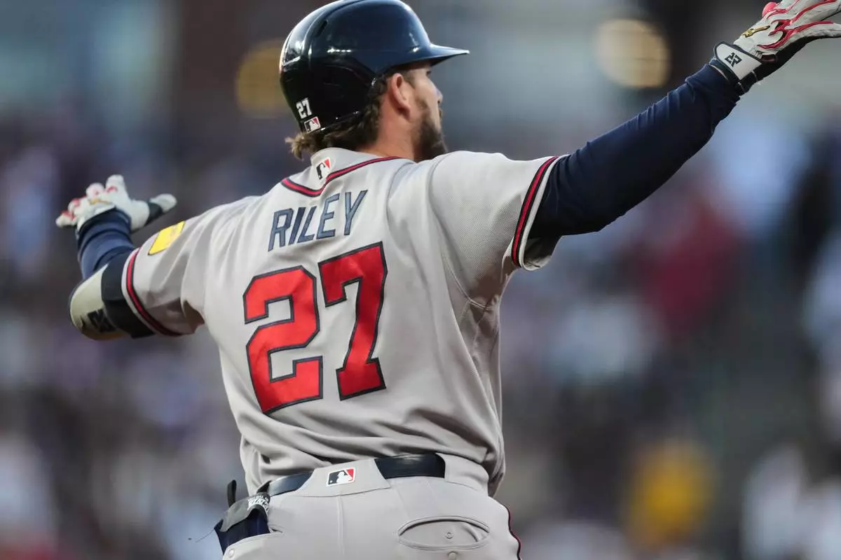 Atlanta Braves' Austin Riley gestures to the bullpen as he circles the bases after hitting a two-run home run off Colorado Rockies relief pitcher Chase Dollander in the fifth inning of a baseball game Saturday, May 2, 2026, in Denver. (AP Photo/David Zalubowski)
