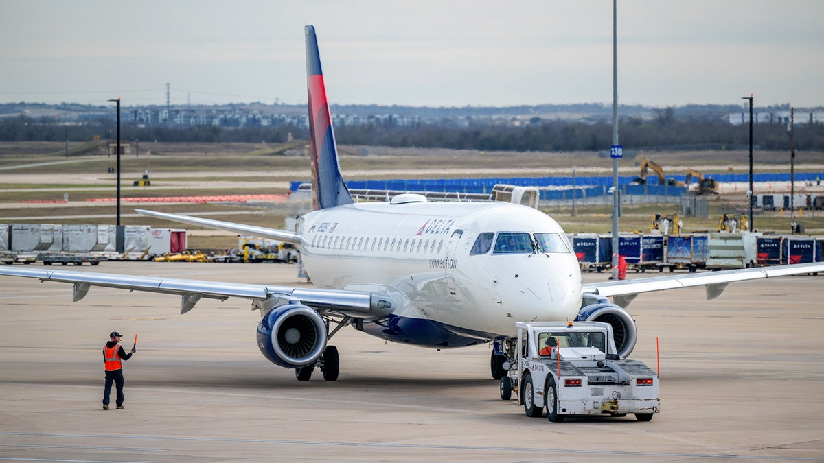 A Delta Airlines plane sitting on the tarmac at Austin-Bergstrom International Airport.