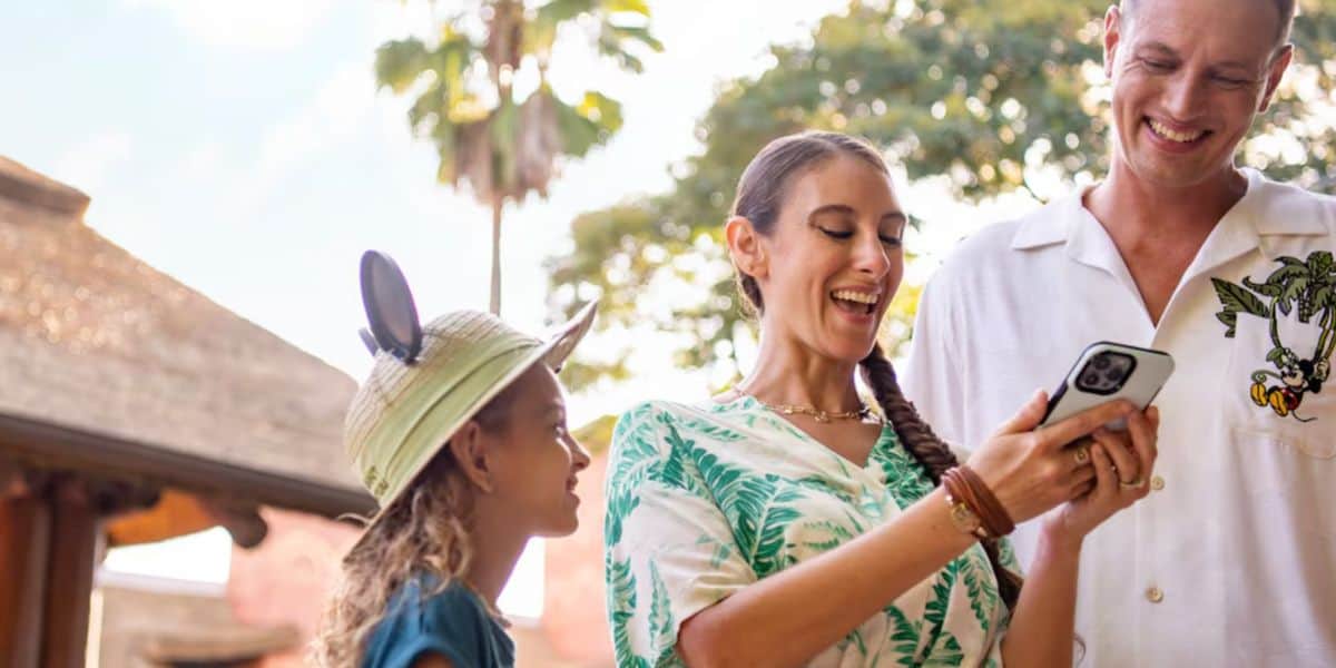 a family uses phone at Disney World