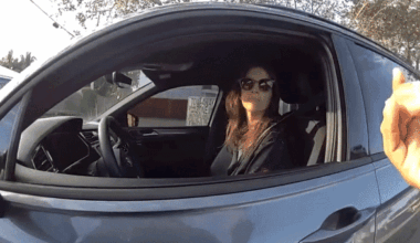Woman with one hand speaking with officer