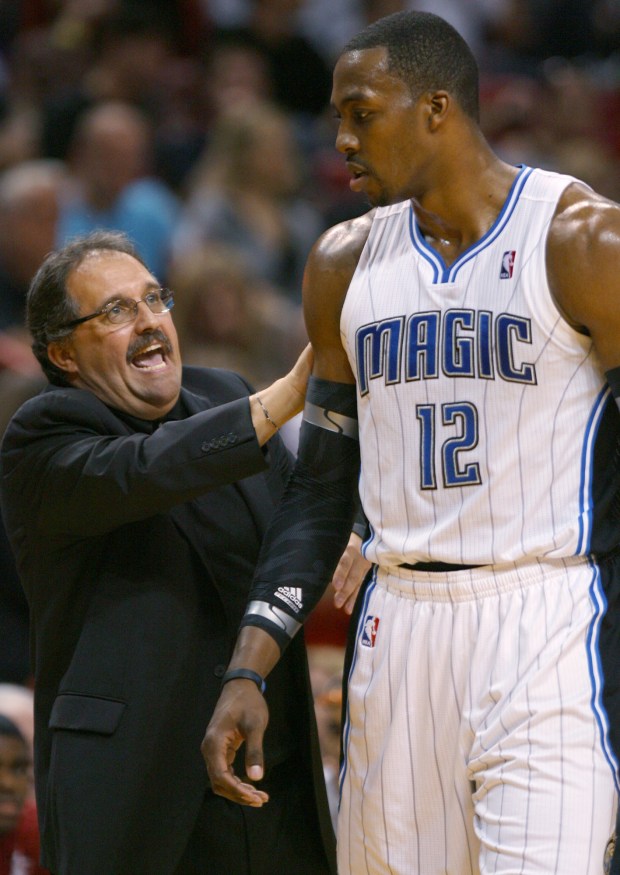 Orlando Magic coach Stan Van Gundy alks to Dwight Howard during the third quarter in an NBA basketball game against the Miami Heat on Sunday, Feb. 19, 2012, in Miami. Miami won 90-78. (AP Photo/El Nuevo Herald, David Santiago) MAGS OUT