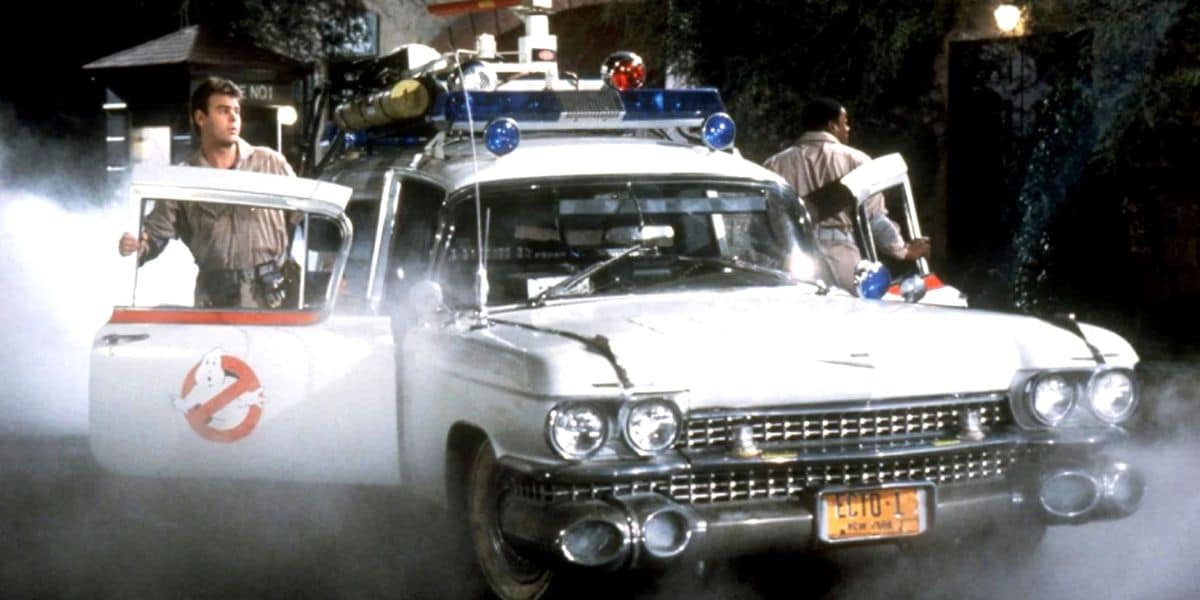The original Ghostbusters around Ecto-1