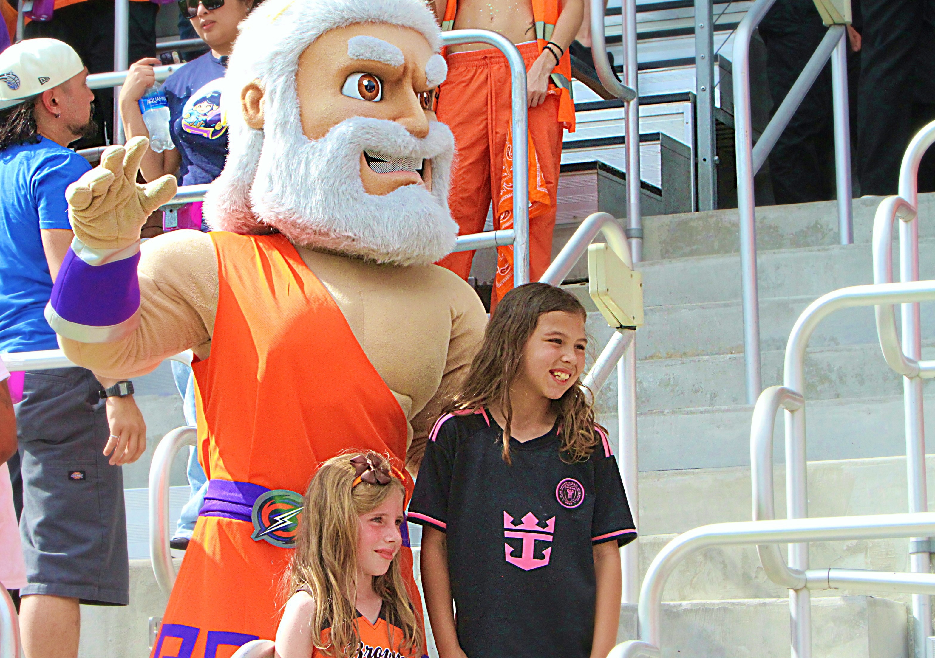 Young Orlando Storm fans pose with Storm mascot Kratos during...