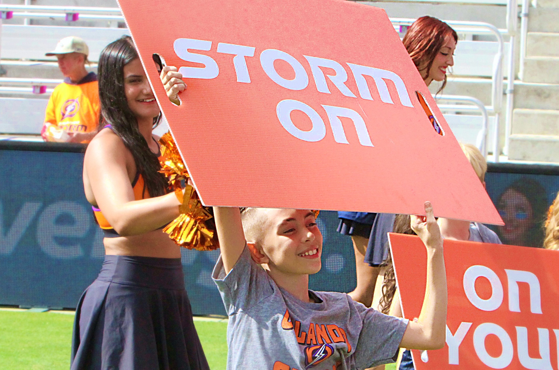 A young member of the Orlando Storm Surge cheerleaders flashes...