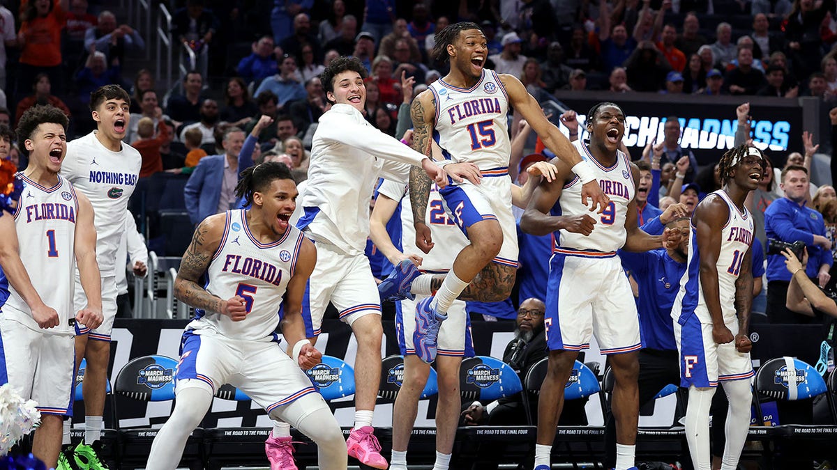 Florida Gators basketball players celebrating on bench during game against Maryland Terrapins
