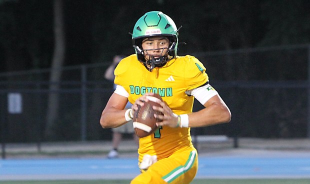 DeLand quarterback Gardner Nordman looks for room to run during the Bulldogs' spring game at TFA on Friday night. (Chris Hays/Orlando Sentinel)