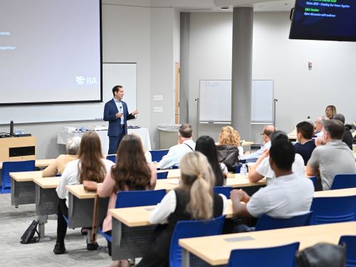 Professor teaching in lecture hall.