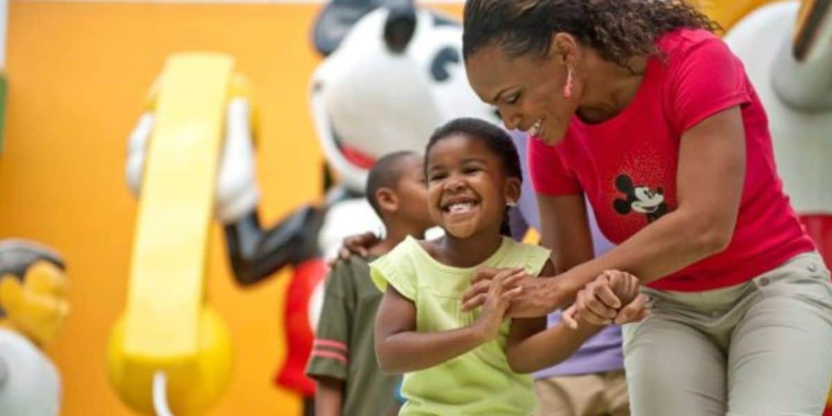 mother and her child in front of mickey statue at pop century resort in disney world