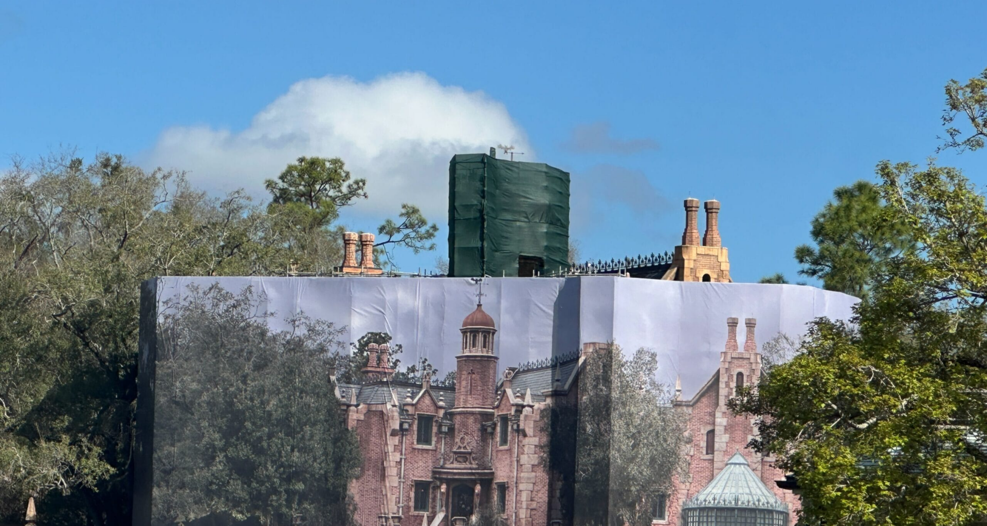 Haunted Mansion behind themed scrim at Magic Kingdom in Walt Disney World