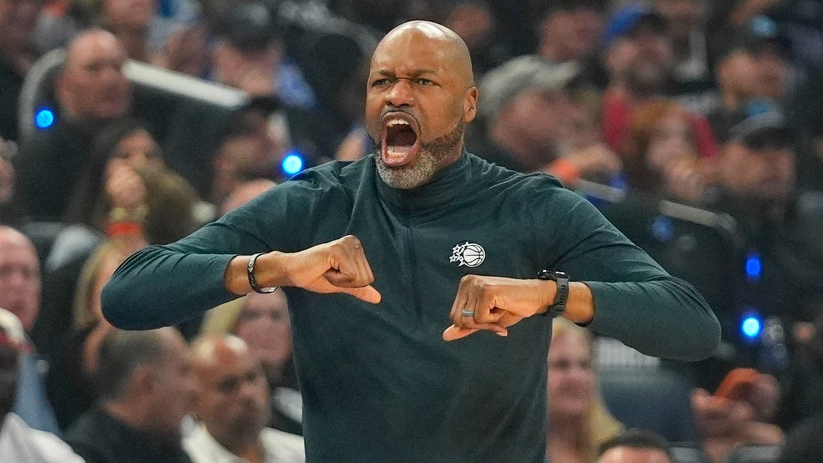 Orlando Magic head coach Jamahl Mosley directing players during a basketball game.