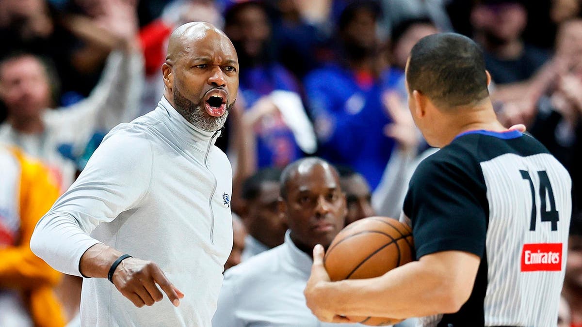 Orlando Magic head coach Jamahl Mosley shouting at referee Curtis Blair during basketball game.