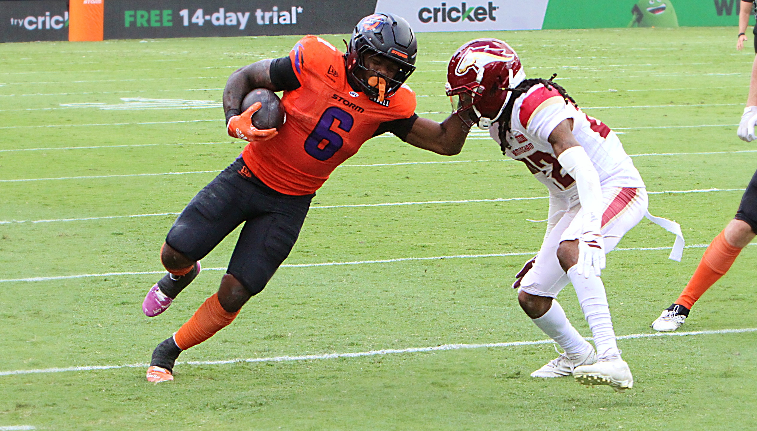 Orlando running back Jashaun Corbin tries to fend off a...