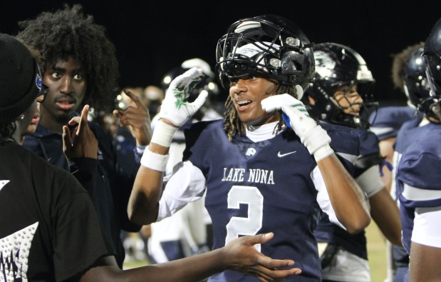New Lake Nona receiver Josiah Hall receives congrats on the sidelines after catching a 31-yard touchdown pass in a 21-0 victory over Boone on Thursday night. (Chris Hays/Orlando Sentinel)