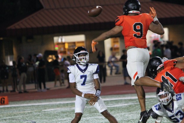 Winter Park's KJ Davis bats down a pass by Winder Pierre Jr., which Pierre Jr. actually ends up catching and running for positive yardage during DP's 42-28 loss to Winter Park in a spring game Tuesday night. (Chris Hays/Orlando Sentinel)