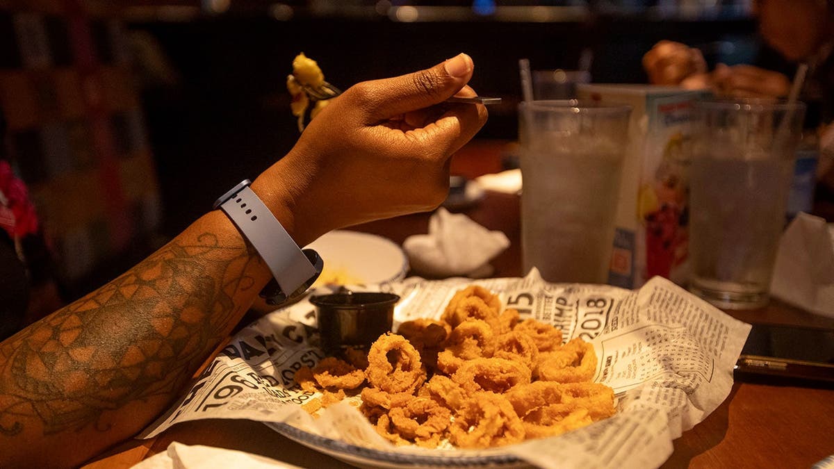 A man eats fried food at Red Lobster.