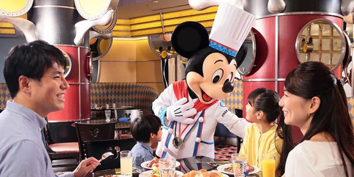 Mickey Mouse meets guest at Chef Mickey, a Disney dining experience. Disney reservation cancellations.