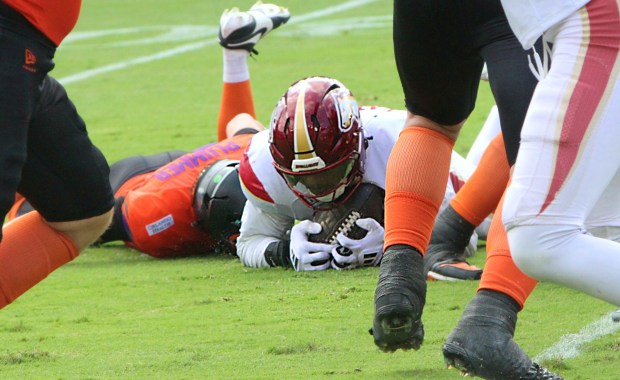 Birmingham's Olakunie Fatukasi recovers a first-quarter fumble by Orlando Storm quarterback Jack Plummer in the first quarter of the Storm's 20-17 loss to the Stallions on Sunday. (Chris Hays/Orlando Sentinel)