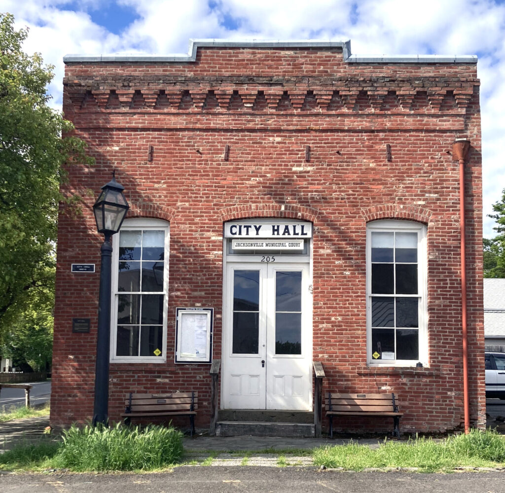 Completed in 1881, Jacksonville’s Old City Hall at 205 W. Main St. was Oregon’s oldest government building in continuous use until it ceased serving as the primary city government headquarters in 2020. Built on the site of an 1874 fire-gutted brick store, it was constructed using recycled bricks, incorporating a town hall, recorder's office, jail (calaboose), and fire station. It will become the Jacksonville History Center, slated for a soft opening July 4, with a grand opening expected to follow in September. Photo: Jim Flint.