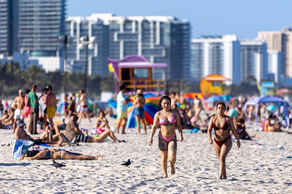 People lounge on South Beach in Miami Beach, Florida.