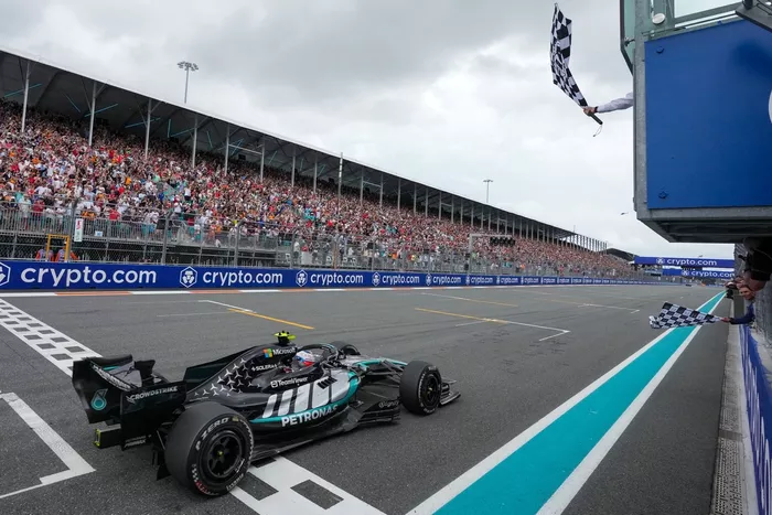 Rafael Nadal waves the checkered flag for Andrea Kimi Antonelli