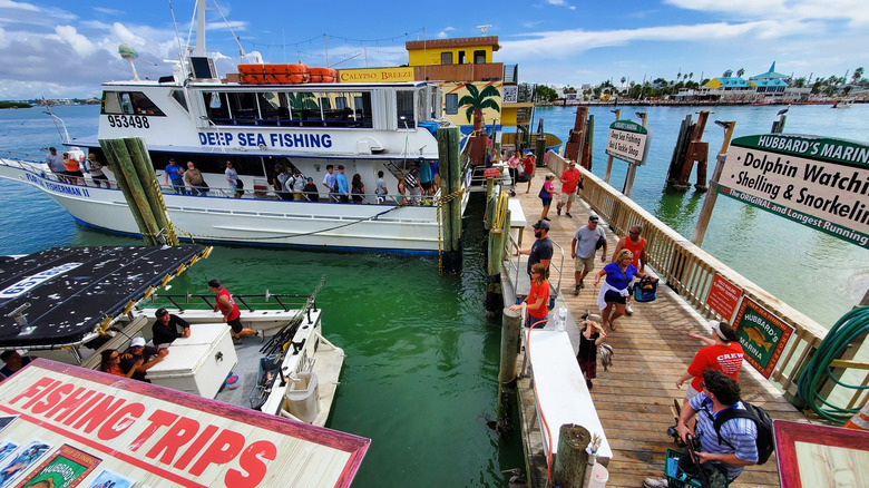 People on a boat and dock at Hubbard's Marina in Madeira Beach, Florida.