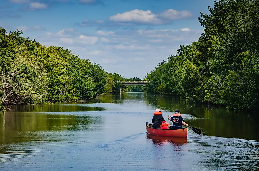 Visitors row a red canoe on Biscayne Bay lagoon at Biscayne National Park.