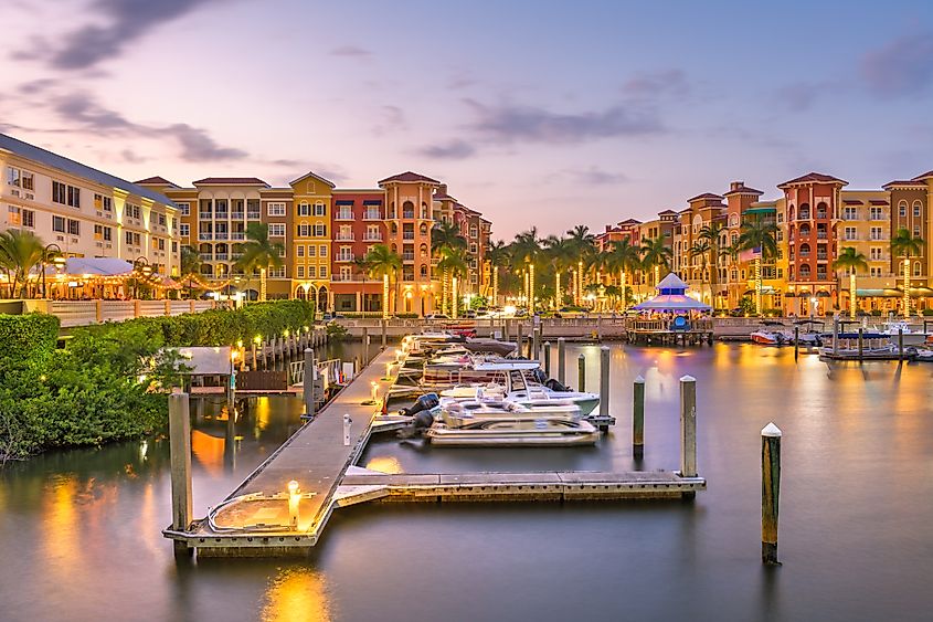Evening view of the marina filled with boats in Naples, Florida.