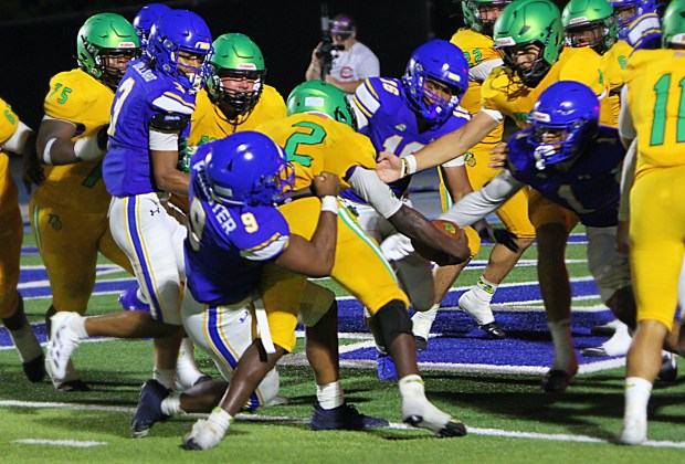 DeLand running back Taihj Moore reached the ball across the goal line for the 2-point conversion that gave DeLand a 36-35 victory over TFA and set off a wild celebration Friday night. (Chris Hays/Orlando Sentinel)
