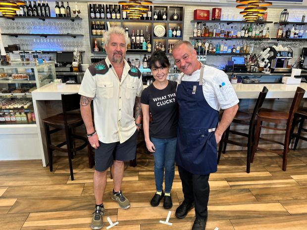 From left, Food Network star Guy Fieri, Delphine Vallone and chef Daniel Vallone inside the dining room of Alaina's Cafe & Bake Shoppe, featured in an April episode of Food Network's "Diners, Drive-Ins & Dives." (Daniel Vallone / Courtesy)