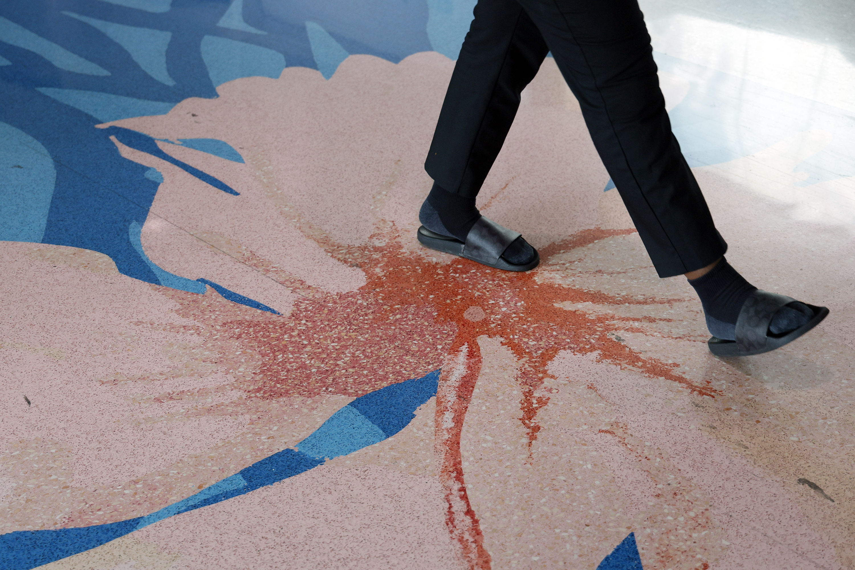 A pedestrian walks across Marielle Plaisirâs terrazzo installation, âA Journey,â...