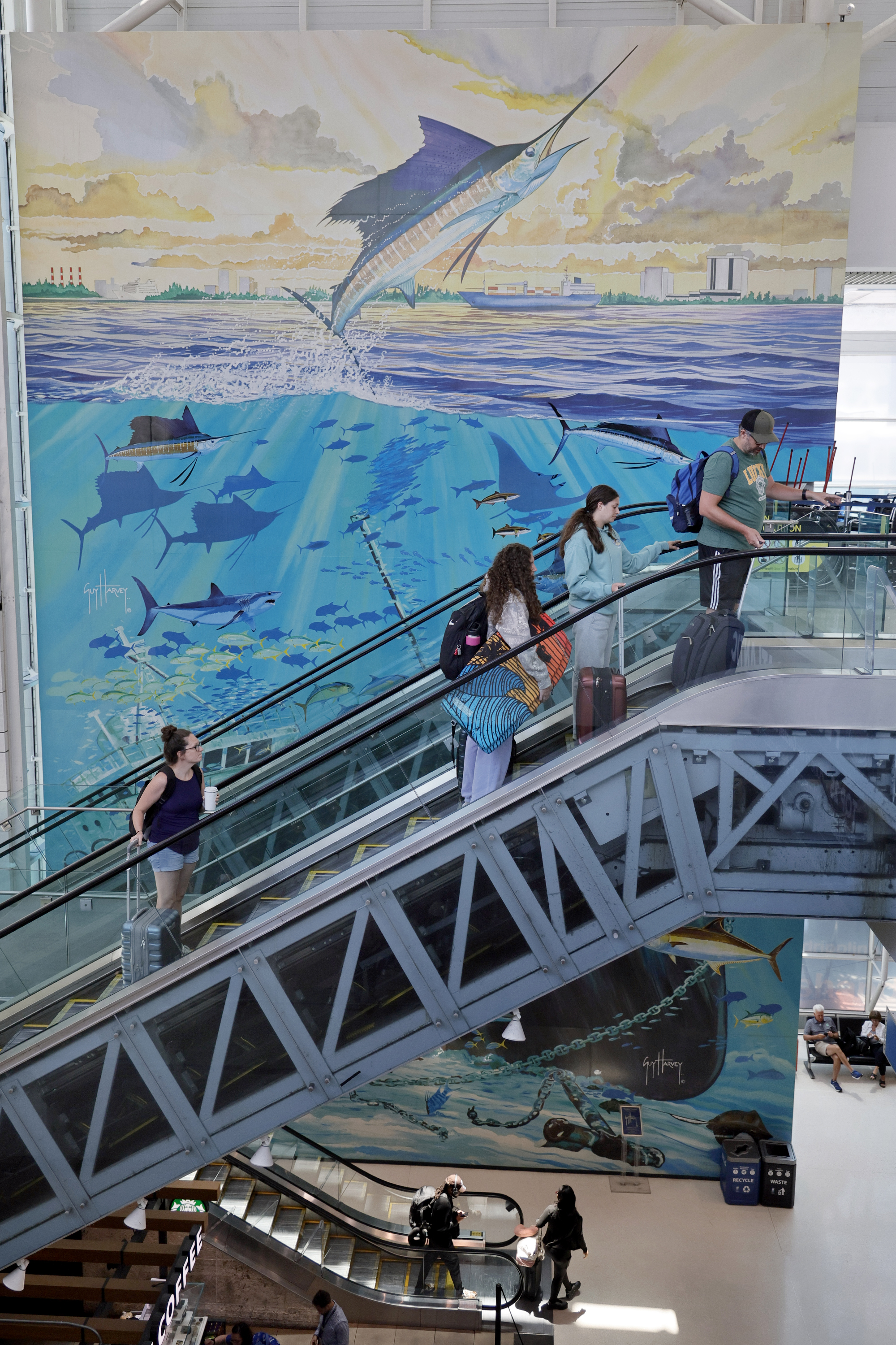 Travelers pass âSunken Treasureâ by Guy Harvey, a three-story, hand-embellished...