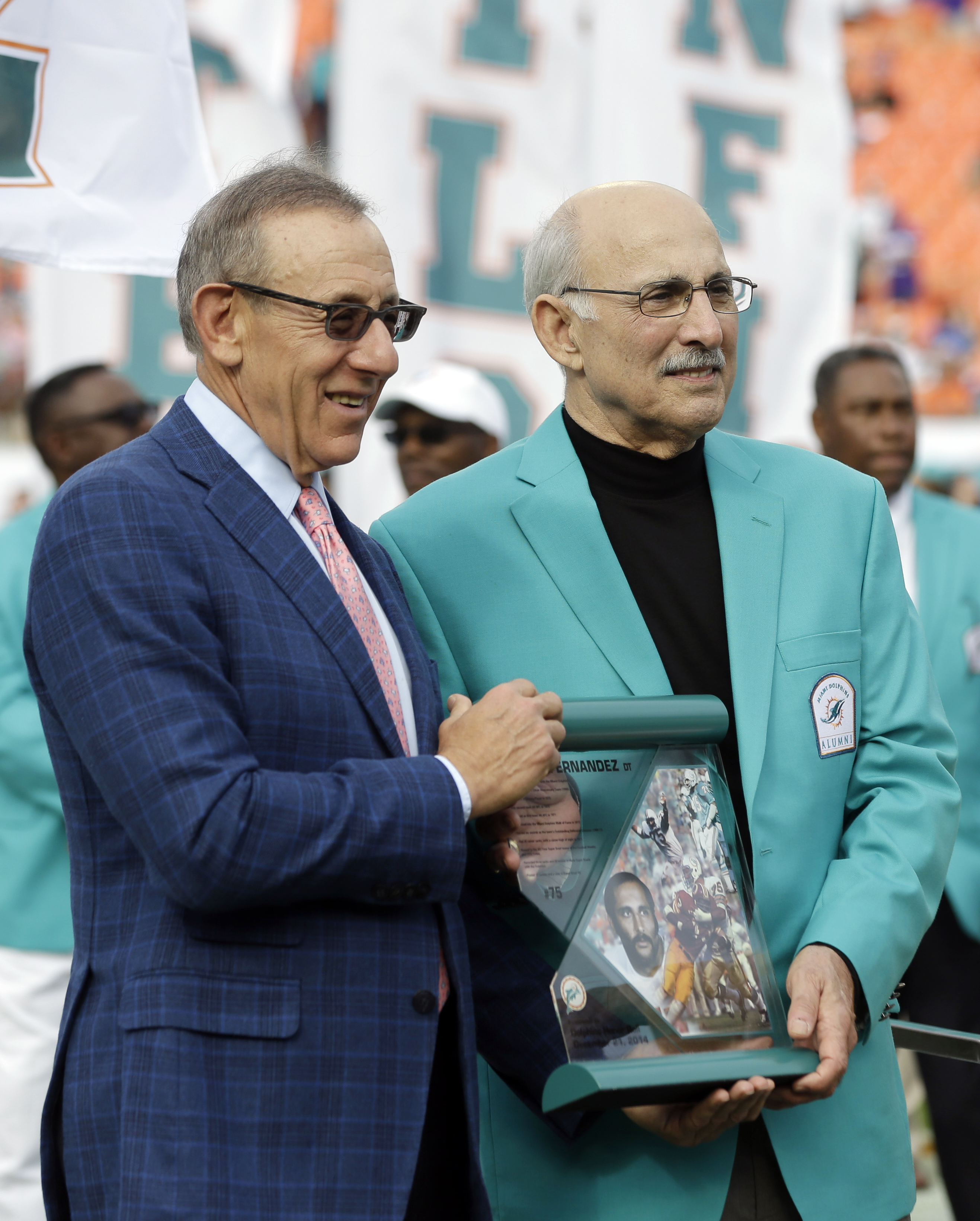 FILE - Miami Dolphins owner Stephen Ross presents former player...