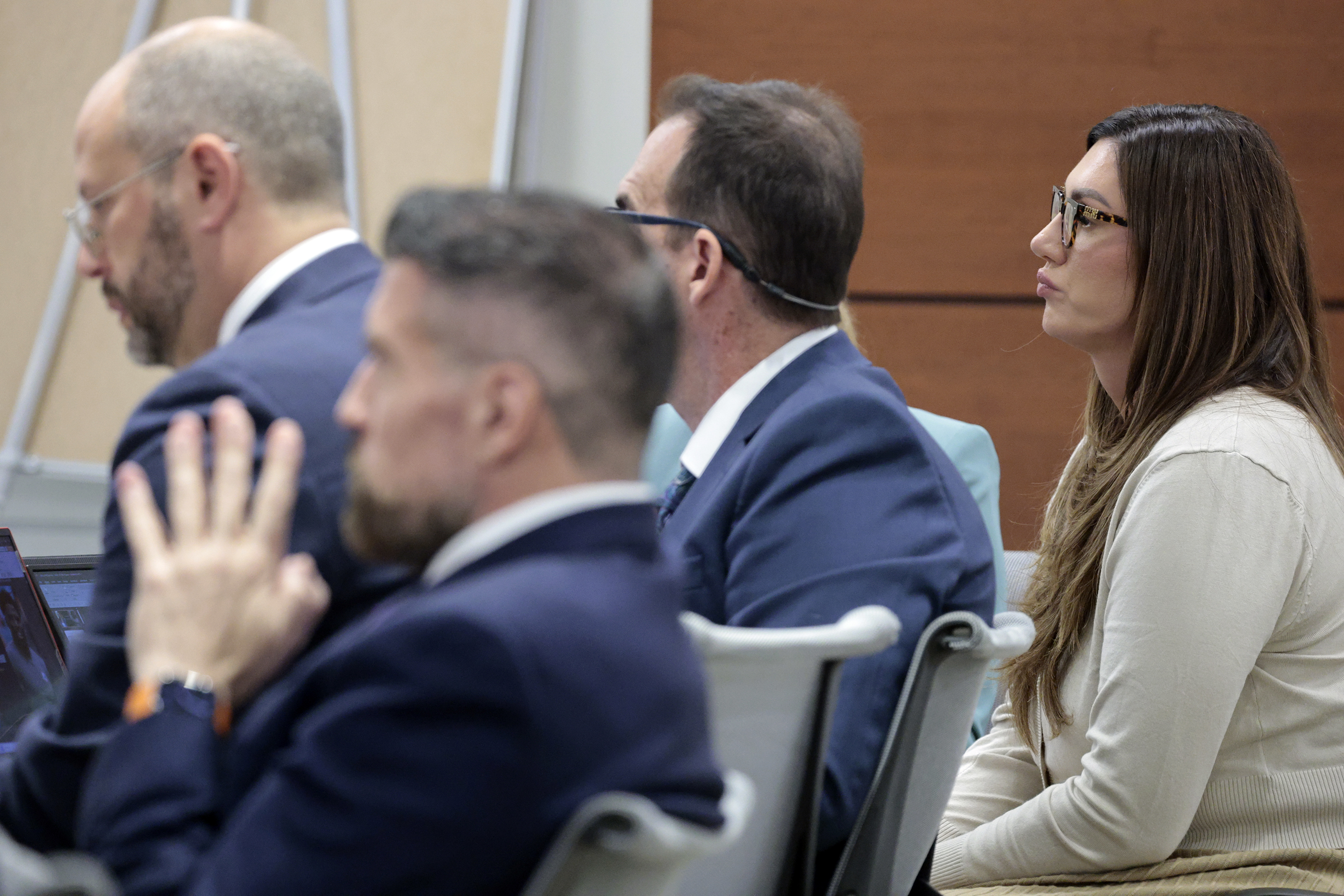 Sophie Hall is shown with her attorneys on the first...