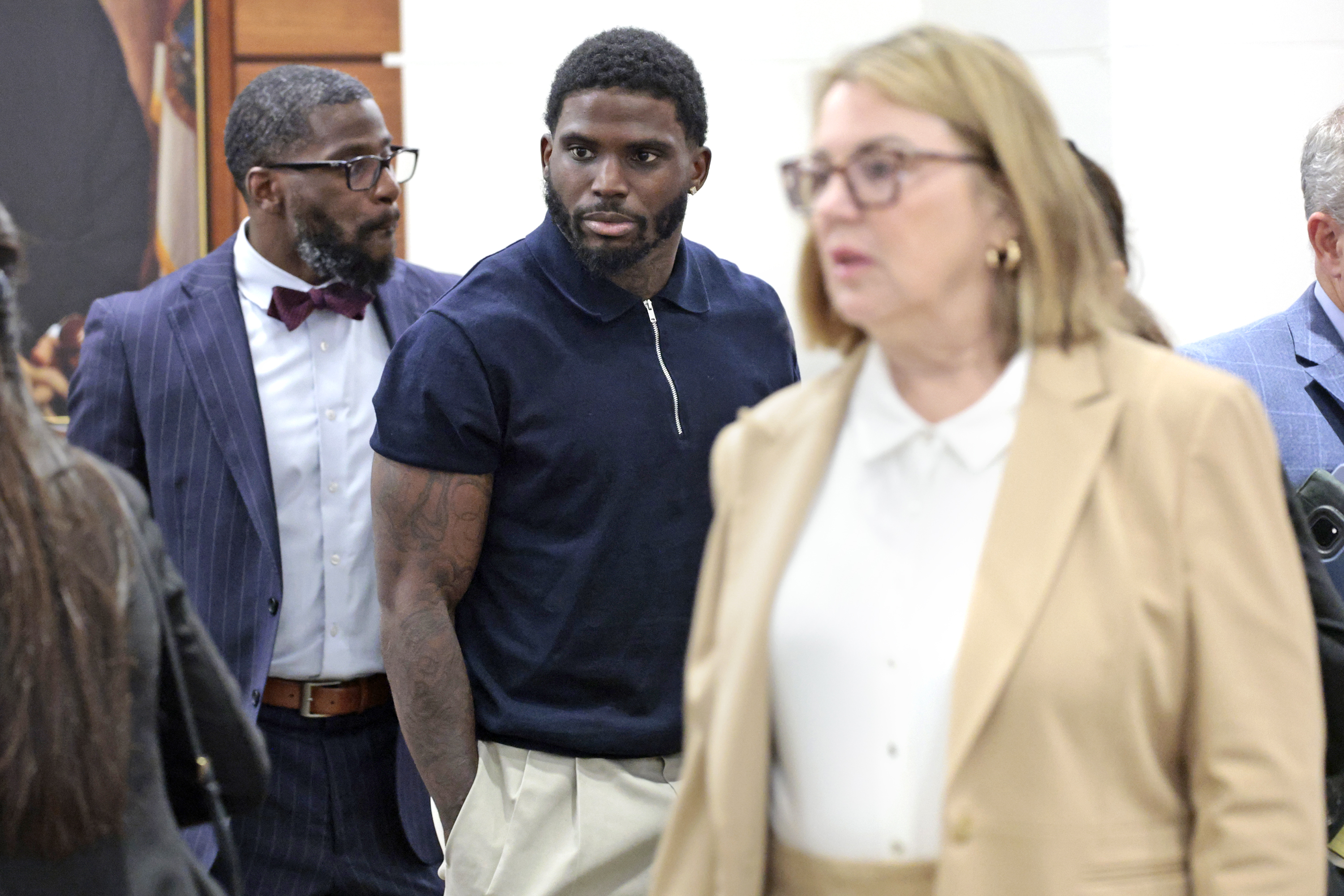 Former Miami Dolphins wide receiver Tyreek Hill enters the courtroom on the first day of his trial at the Broward County Courthouse in Fort Lauderdale on Thursday, May. 7, 2026. A lawsuit brought by Sophie Hall, a social media influencer and model, claims that Hill intentionally broke her leg during a backyard football lesson at his Southwest Ranches home. Her attorneys are suing Hill for battery, assault, intentional infliction of emotional distress, and negligence. (Amy Beth Bennett / South Florida Sun Sentinel)
