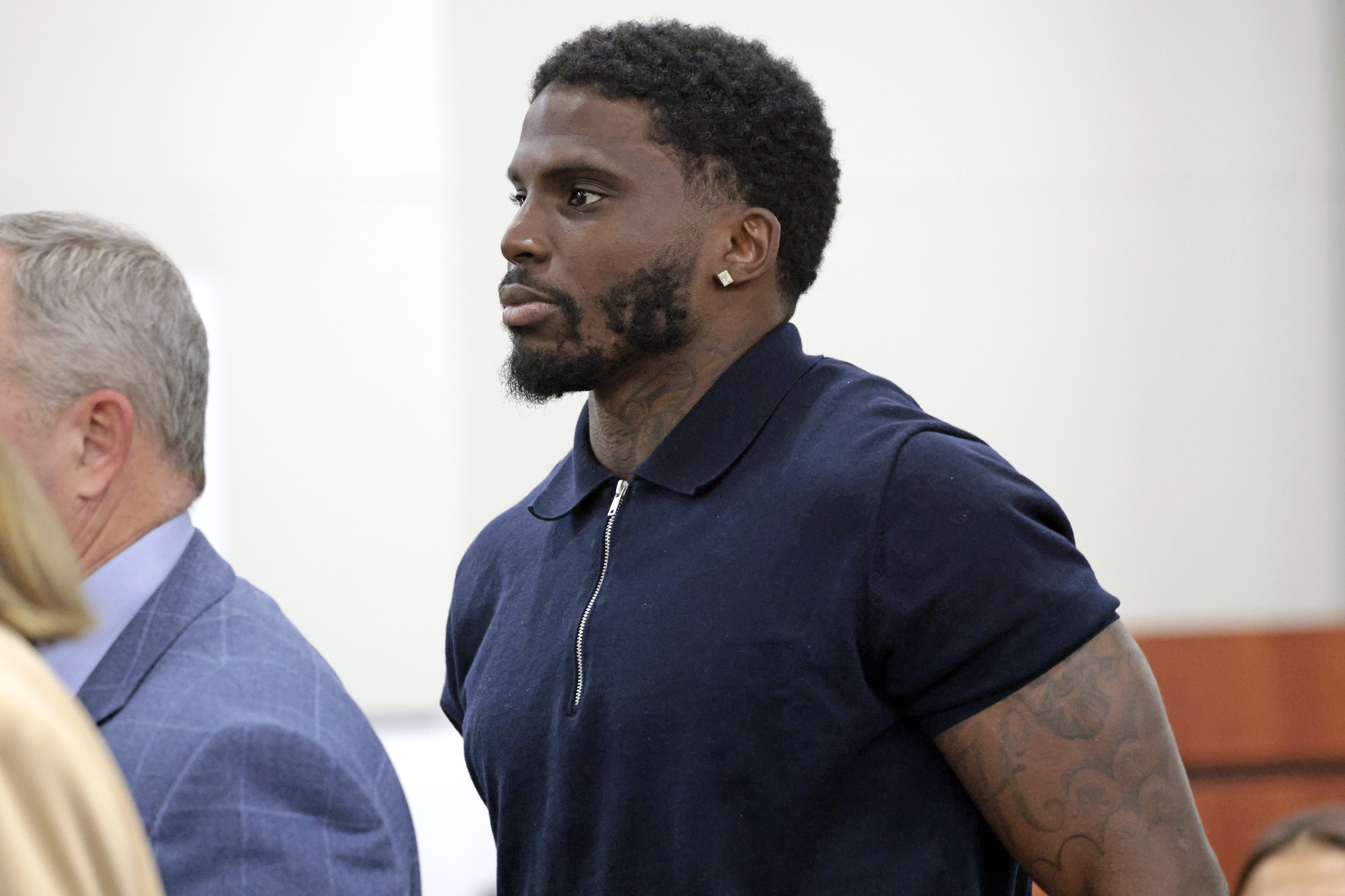 Former Miami Dolphins wide receiver Tyreek Hill enters the courtroom...