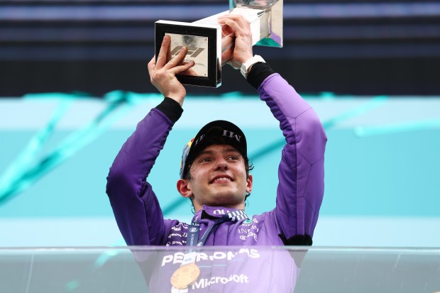 Kimi Antonelli lifts the trophy on the podium after winning the F1 Grand Prix of Miami at Miami International Autodrome on Sunday in Miami Gardens. (Photo by Peter Fox/Getty Images)