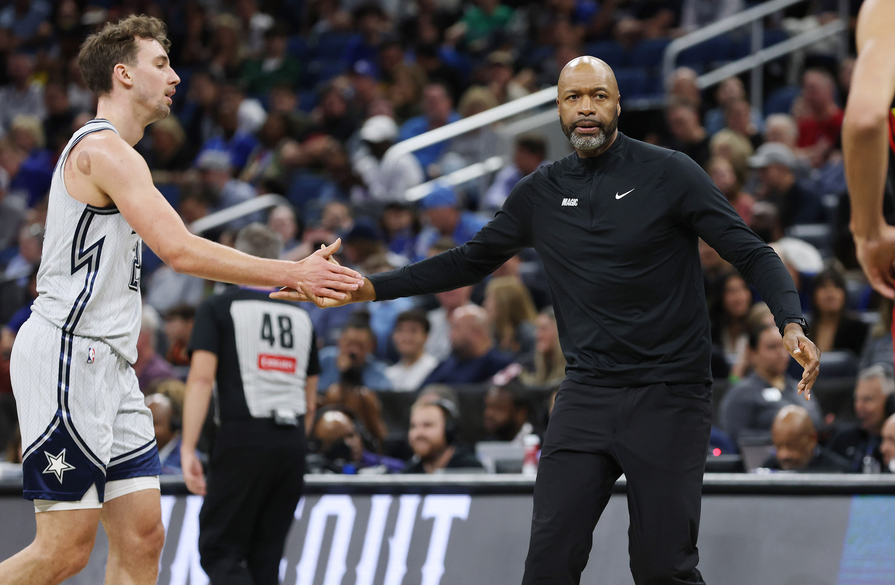 Orlando Magic coach Jamahl Mosley greets forward Franz Wagner during...