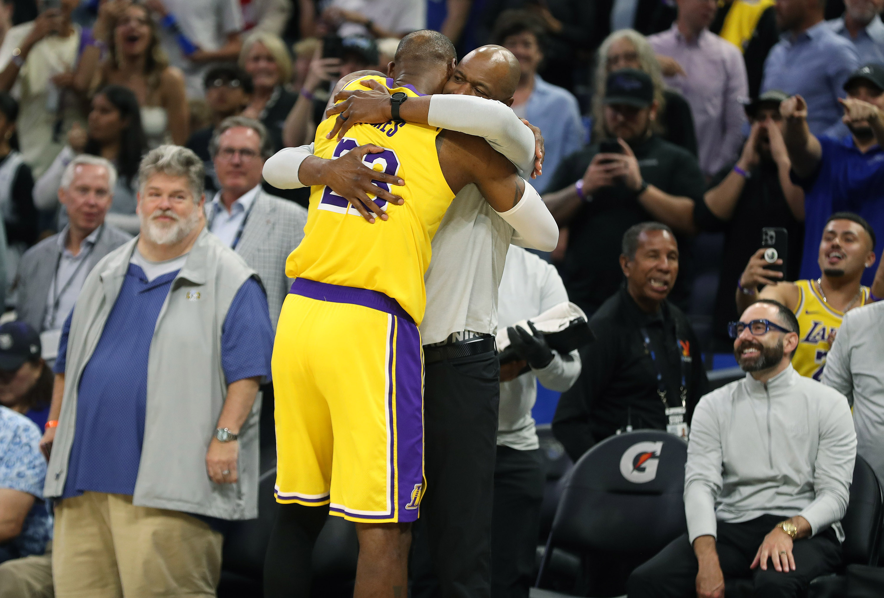 Los Angeles Lakers forward LeBron James (23) hugs Orlando Magic...