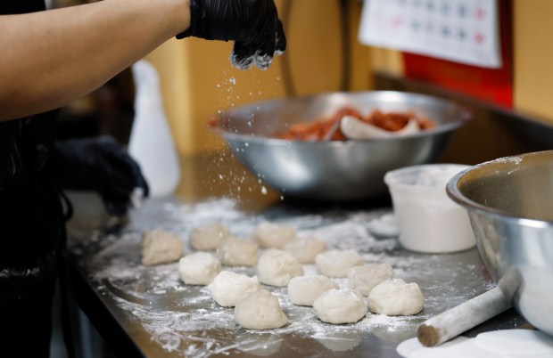 Chef Jackie Lau dusts flour on dough while preparing Steamed Char Siu Bao at Moon Wok, on Monday, May 18, 2026. (Ricardo Ramirez Buxeda/ Orlando Sentinel)