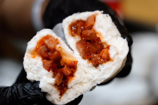 Chef Jackie Lau shows the inside of Steamed Char Siu Bao at Moon Wok, on Monday, May 18, 2026. (Ricardo Ramirez Buxeda/ Orlando Sentinel)