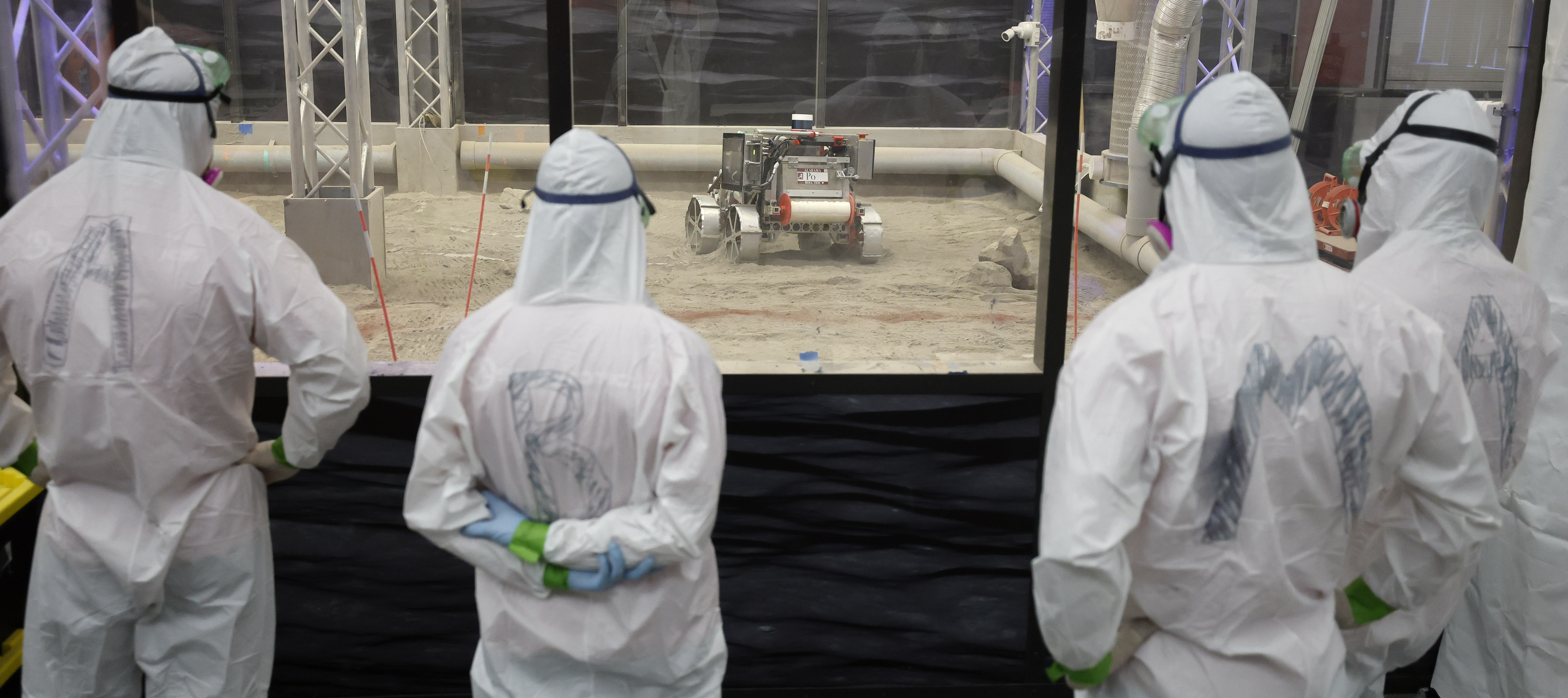 The University of Alabama team members watch their robot make...